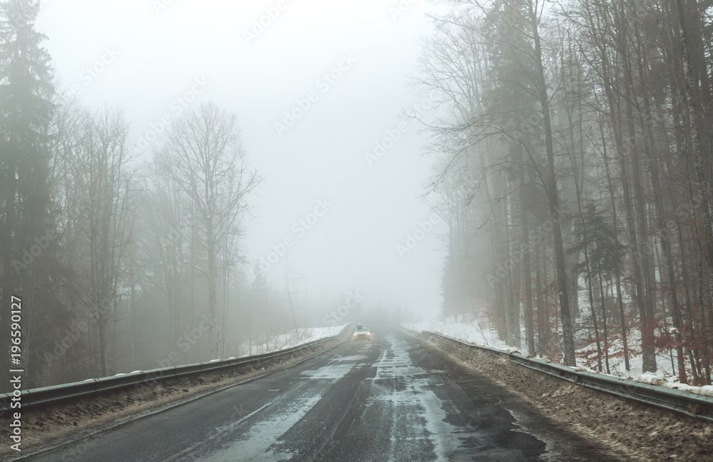 Foggy road in the mountains. Winter trip to the Carpathian Mountains, Eastern Europe Foggy road in the mountains. Winter trip to the Carpathian Mountains, Eastern Europe
