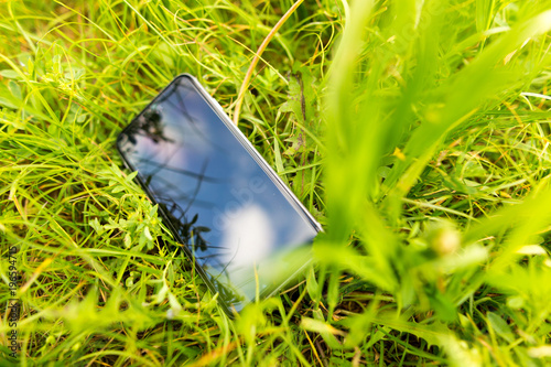Grass in reflection of a cell phone in nature