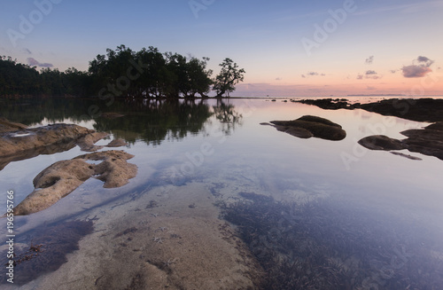 sunset seascape with natural coastal rocks.