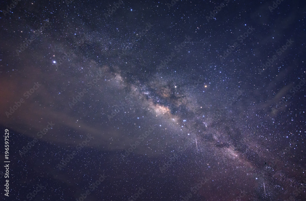 milky way galaxy during cloudy dark sky. image contain soft focus, blur and noise due to long expose and high iso.