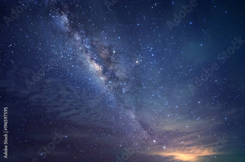 milky way galaxy during cloudy dark sky. image contain soft focus, blur and noise due to long expose and high iso.