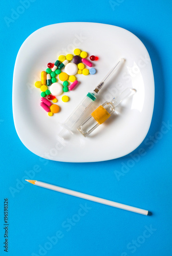 Pills plate concept of antibiotic food vitamins in capsules and tablets. nutritional supplements 