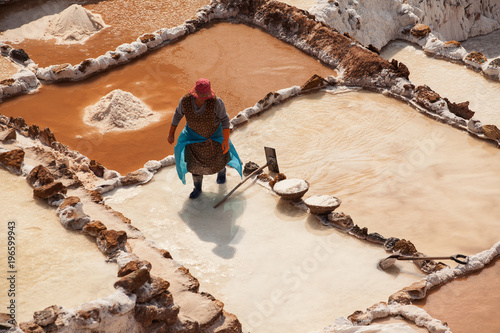 Woman working at the salt terraces in Maras
