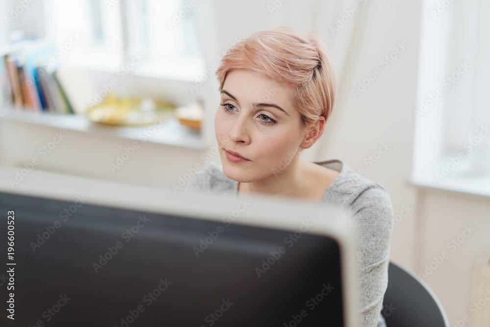 Young businesswoman working on a large monitor Young businesswoman working on a large monitor