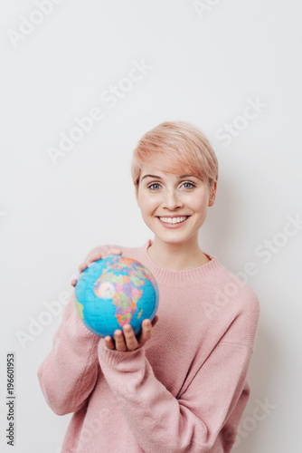 Pretty woman with short haircut holding globe