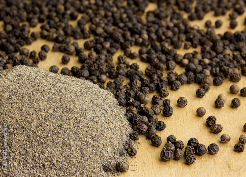 Pile of black pepper on a wooden table