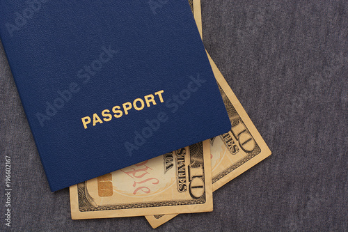 Dollars in blue passport on a blue background, close-up photo