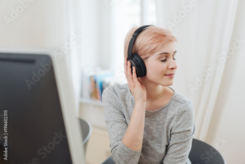 Pretty young woman enjoying music
