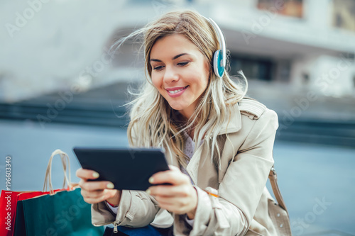 Happy woman watching media content in a digital tablet photo