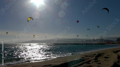 Many Kitesurfers in a sunny day in Spain, in Costa Brava, near the town Palamos