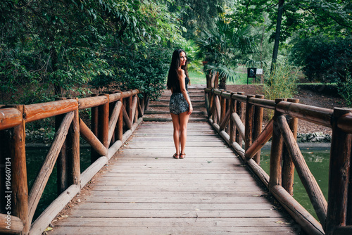 Young woman on wooden bridge