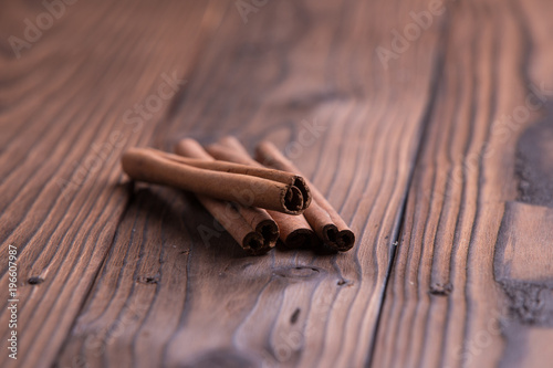 Cinnamon sticks on brown wooden background