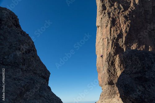 Rock climber on a mountain Roque Nublo. Mountain climbing © theartofpics