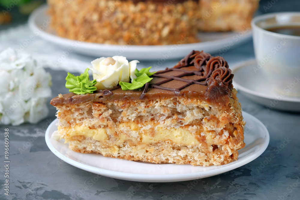 Slice of ukrainian Kiev cake on saucer. Homemade baking.