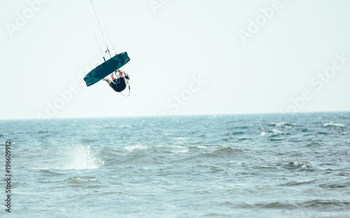 Kitesurfing Kiteboarding action photos man among waves quickly goes