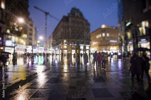 night and rainy city streets with people walking  © babaroga