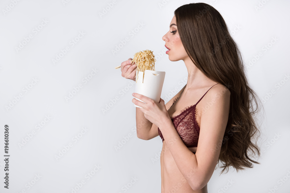 Resistente Demon Play Sin alterar side view of sexy girl in lace lingerie eating noodles with chopsticks  isolated on white foto de Stock | Adobe Stock