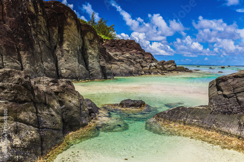 Black Rock  tropical beach surrounded by black rocks  Rarotonga  Cook Islands