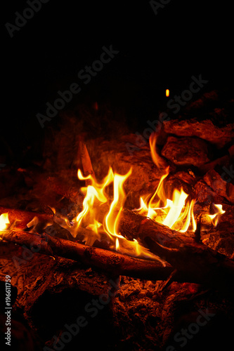 Flame on a black background in natural conditions at night.