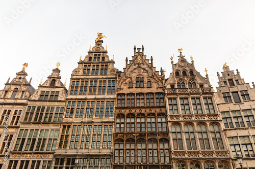 low angle view of beautiful buildings with statues in historic quarter of Antwerp, Belgium
