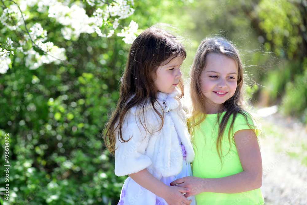 Girls with happy and serious faces hug each other Girls with happy and serious faces hug each other