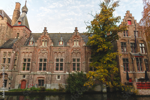 beautiful ancient architecture reflected in canal at brugge, belgium