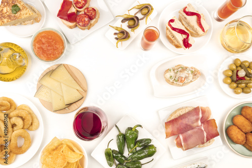 An overhead photo of Spanish tapas, forming frame on white with place for text