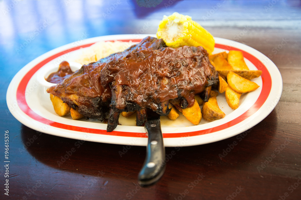 Grilled steak - Grilled meat ribs on the plate with hot sauce