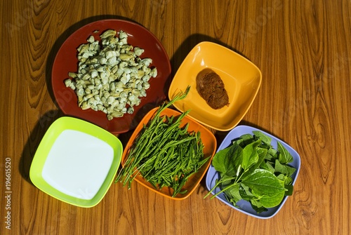 Ingredients Clams Roasted Curry/Surf clam roasted Curry in a white bowl on brown wooden floor. photo