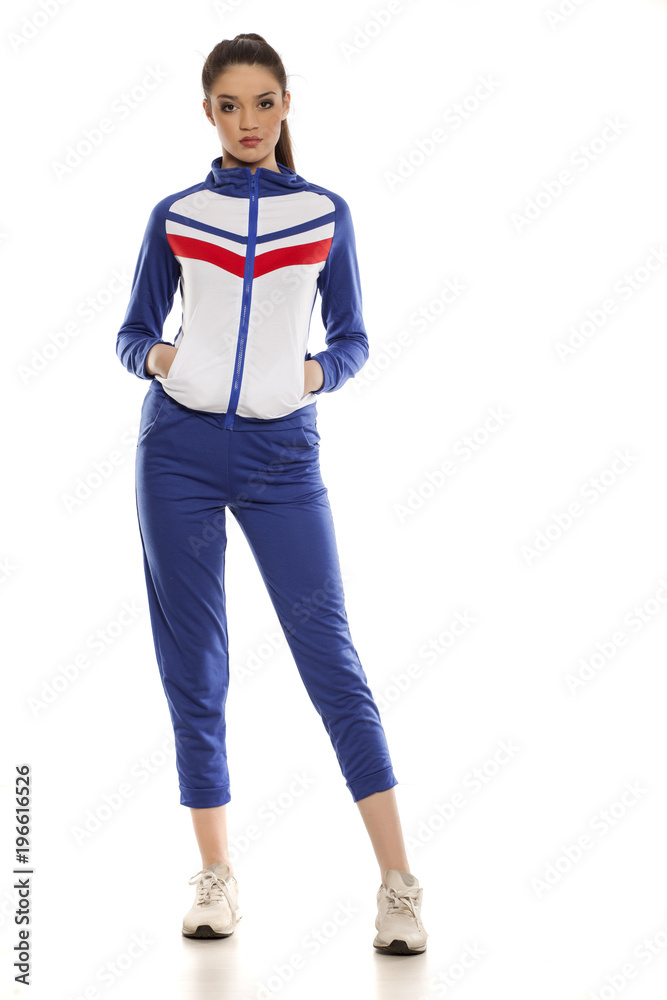 Fototapeta premium young women in blue tracksuits on a white background