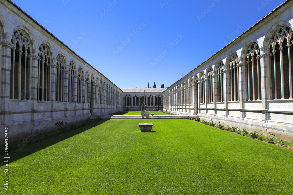 Renaissance monastery courtyard with the green grass in the Pisa Italy