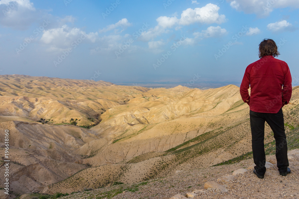 a man is looking in the Judean desert, Israel