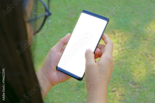 Female hand holding the smartphone Black and Green nature