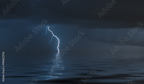 lightning bolts reflection over the sea. taken during a thunderstorm over the ocean with clouds in the background