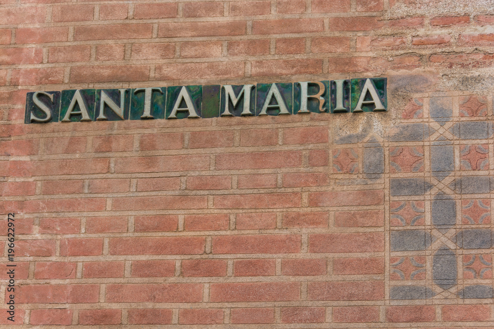 Santa Maria ceramic tile sign on a brick wall