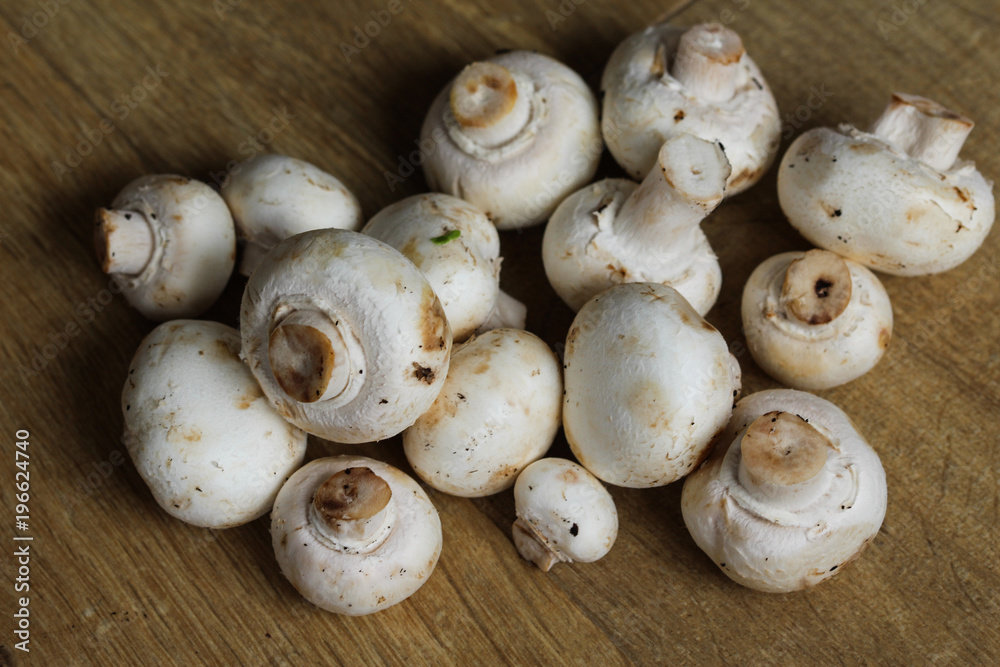 white button Common mushroom (Agaricus bisporus) on wooden table background