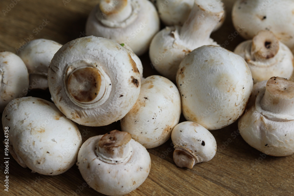 white button Common mushroom (Agaricus bisporus) on wooden table background