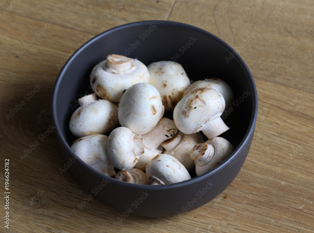 white button Common mushroom (Agaricus bisporus) on wooden table background