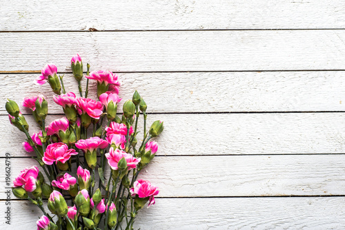 Spring flowers bouquet on table, overhead on white wooden background, flat lay, top view