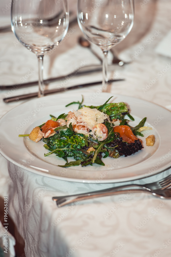 delicious salmon salad with egg in a restaurant. small portion delicious salmon salad with egg in a restaurant. small portion