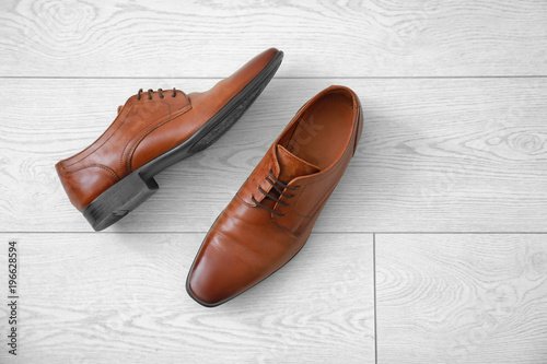 Elegant male shoes on wooden floor