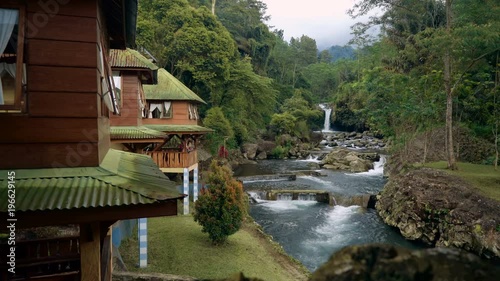 Ketenger Tourism Village at river with waterfall in Baturraden, Indonesia photo
