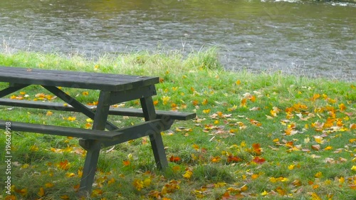 Woody Bench and Beautiful River in Autumn in Scotland, near Abbotsford House photo