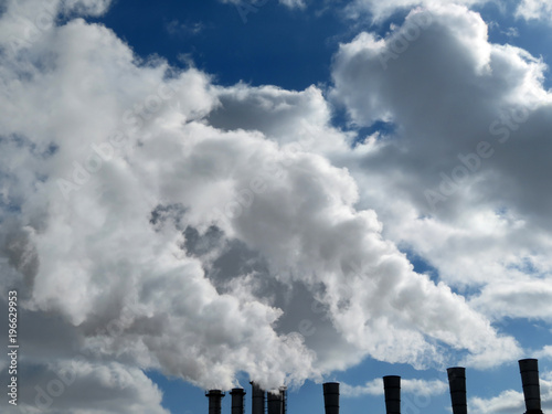 Air pollution. Smoking pipes on a background of the cloudy sky