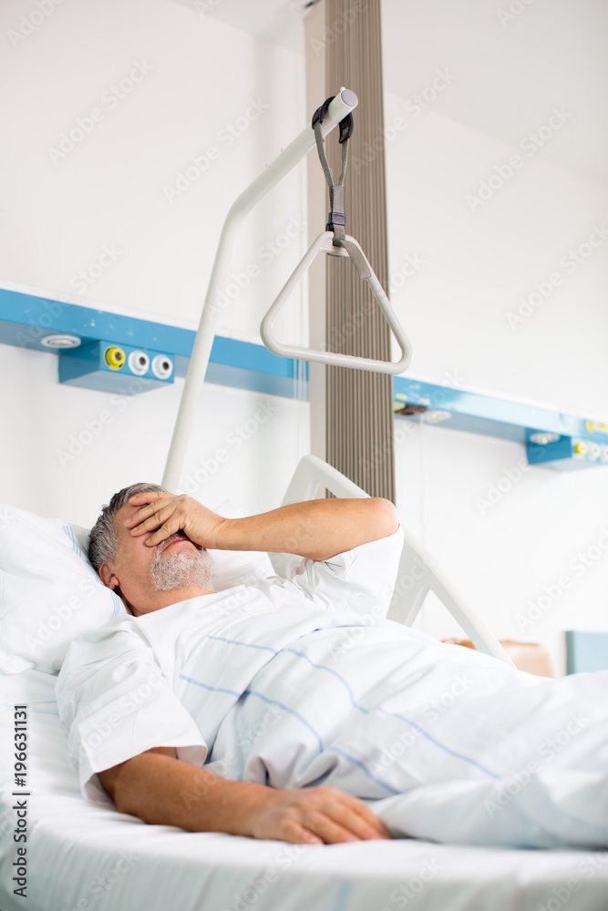 Patient in hospital room - suffering from pain after surgery Patient in hospital room - suffering from pain after surgery