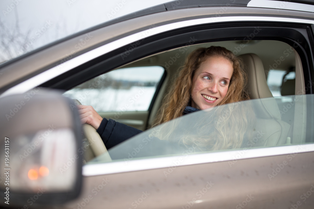 Pretty young woman driving her new car (shallow DOF; color toned image) Pretty young woman driving her new car (shallow DOF; color toned image)
