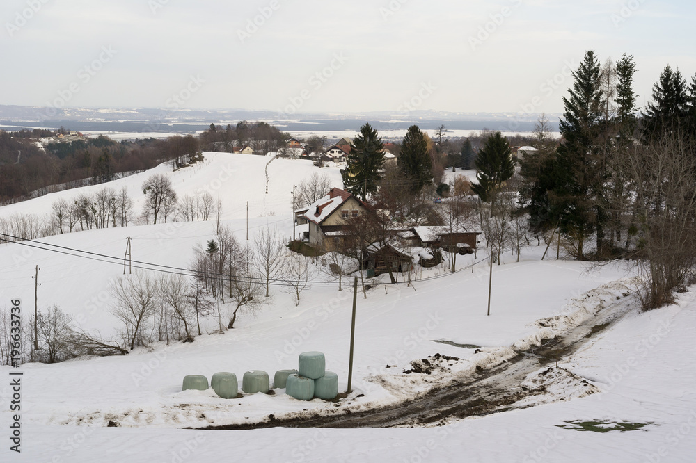 Auhentic ugly and messy countryside and village in the Central Europe during winter and wintertime. Country is covered by white snow