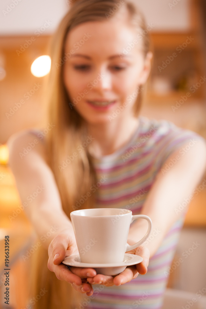 Happy woman holding cup of tea of coffee Happy woman holding cup of tea of coffee