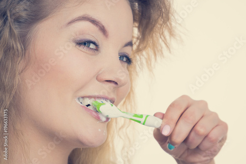 Woman brushing cleaning teeth