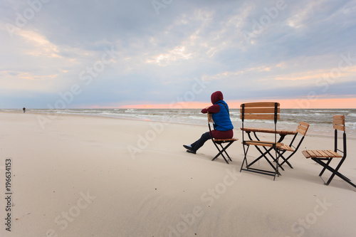 Woman sitting on beach relaxing © Voyagerix